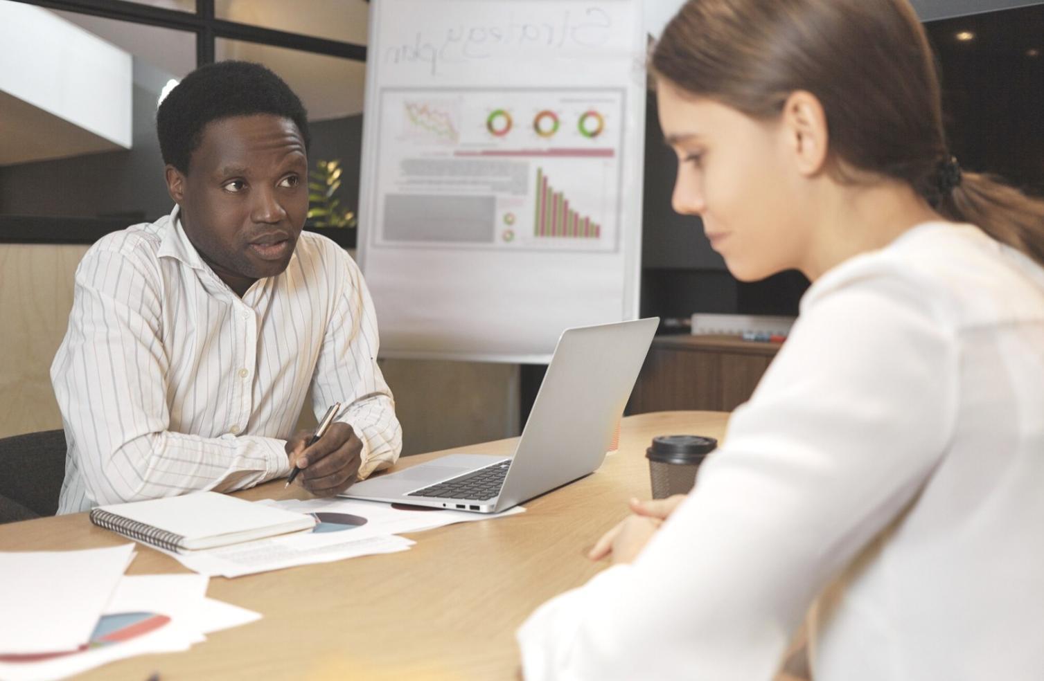 Business professional reviewing financial documents and budget planning materials