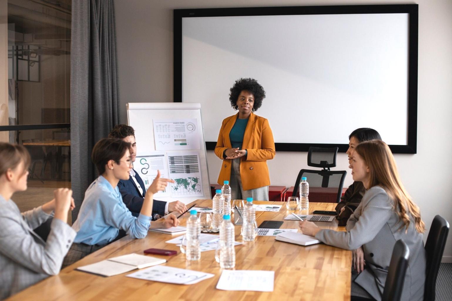 Professional workspace with budget planning materials and laptop displaying financial analysis
